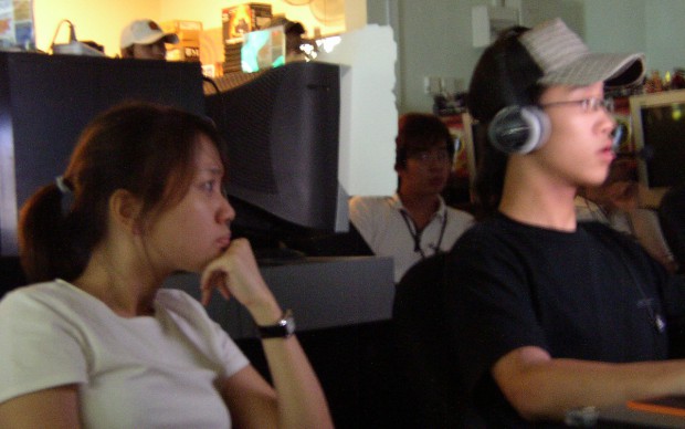 Amanda (left) watches on as Weiqiang plays his match.